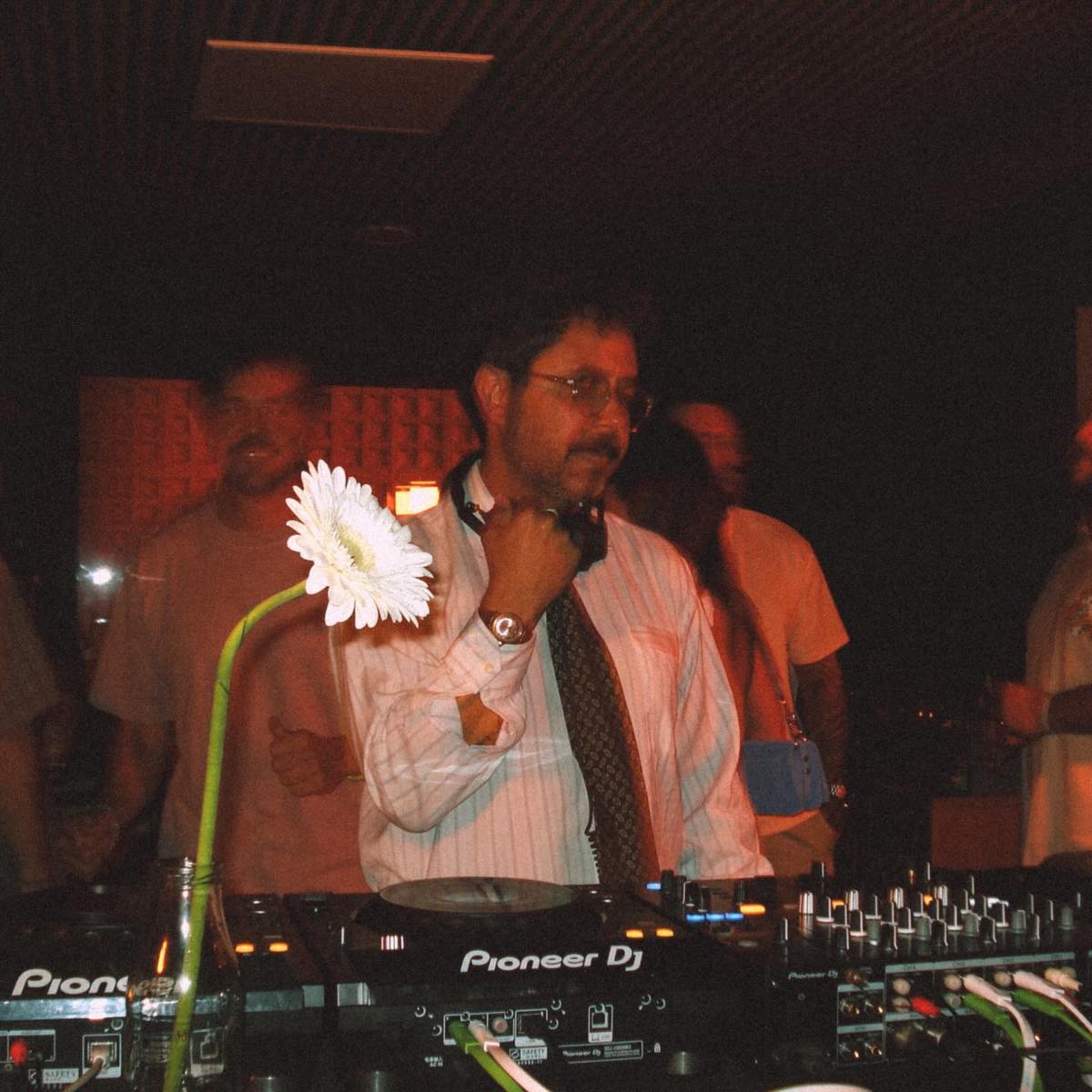 DJ with a flower on the mixer